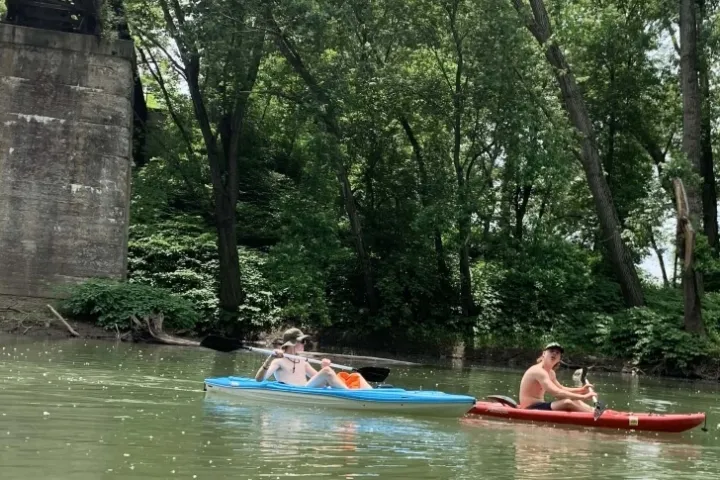 a group of people riding on the back of a boat in the water