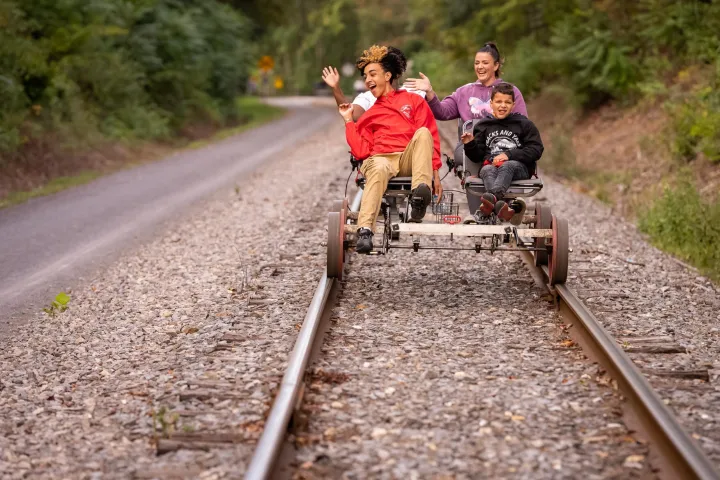 a person riding a bike down a dirt road