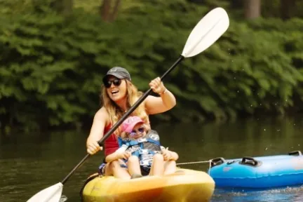 a person riding on the back of a boat in a body of water