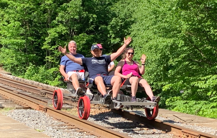 a group of people sitting on a bench in a park