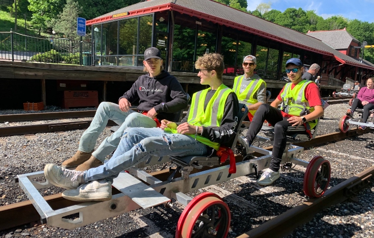 a group of people sitting on a motorcycle