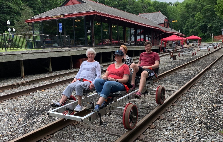 a group of people sitting on a train track