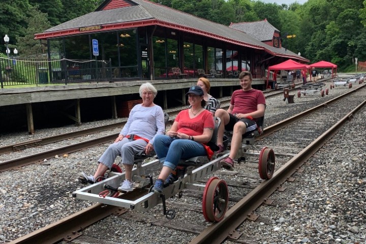 a group of people sitting on a train track